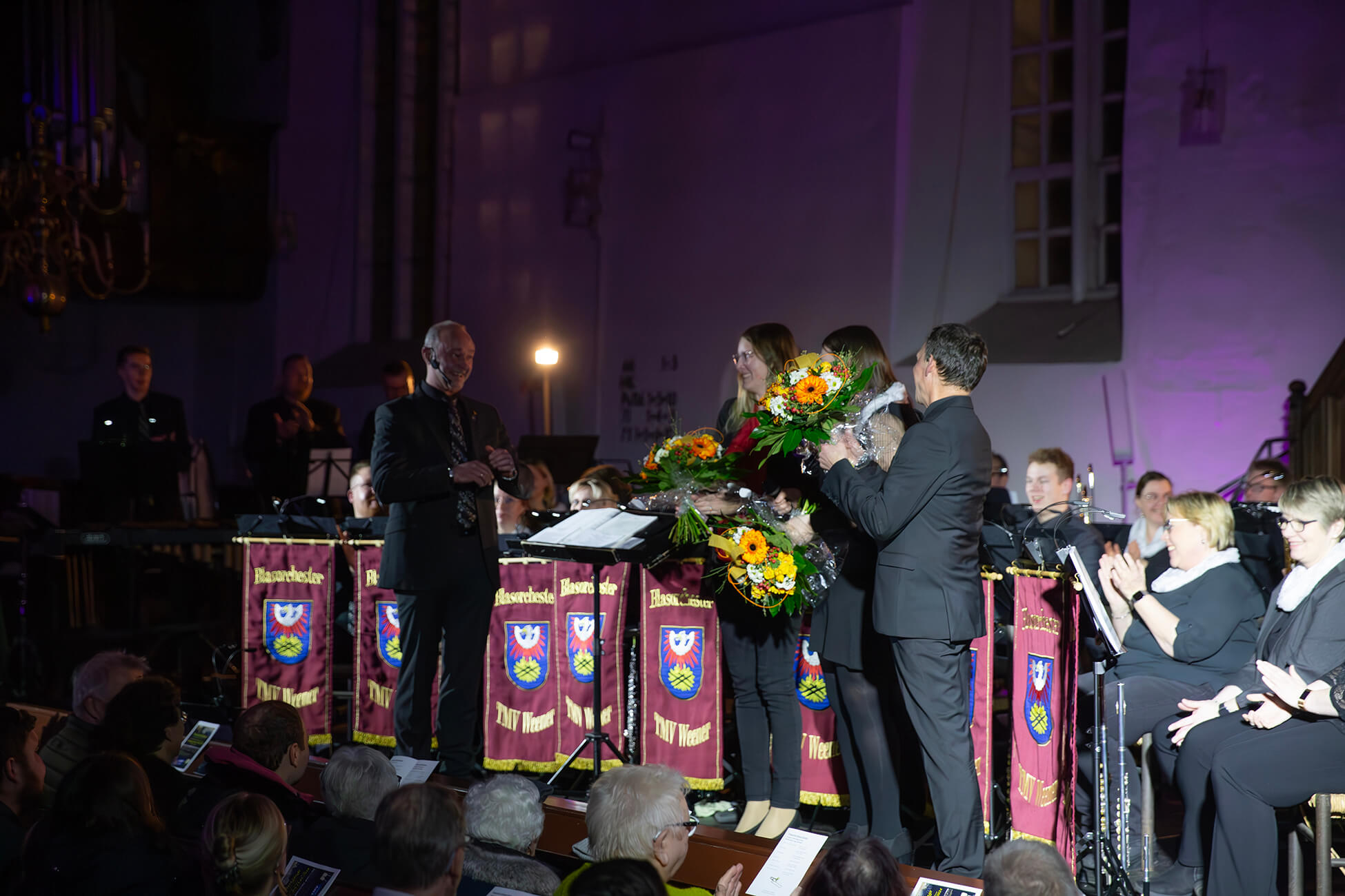Chris standing up holding his daughter Elva